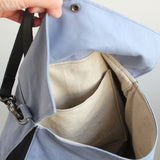 Handmade, waxed cotton handbag showing inside linen pockets.
